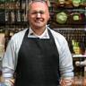 Tom Murphy next to kitchenware stand
